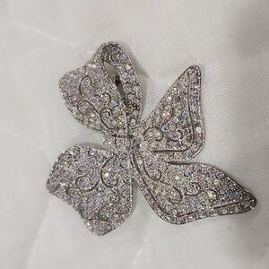 Beautiful Silvertone Bow Pin crusted with Crystals